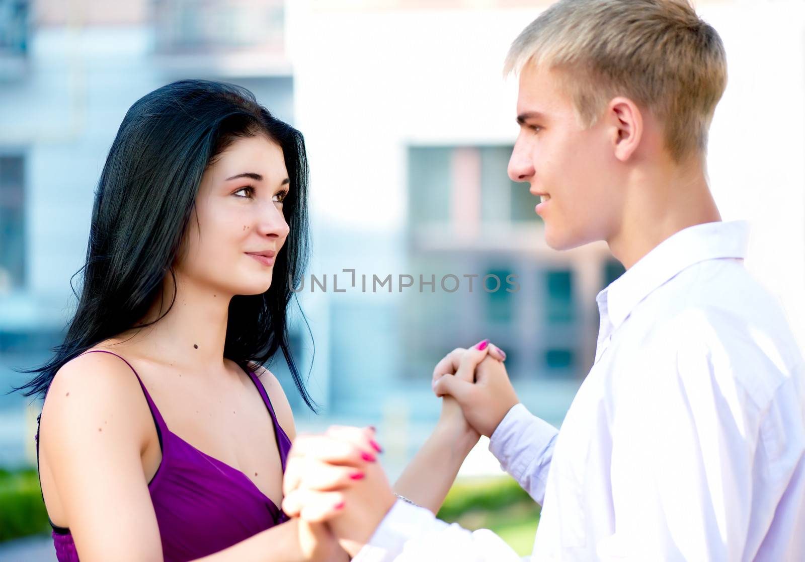 Young attractive smiling couple on street