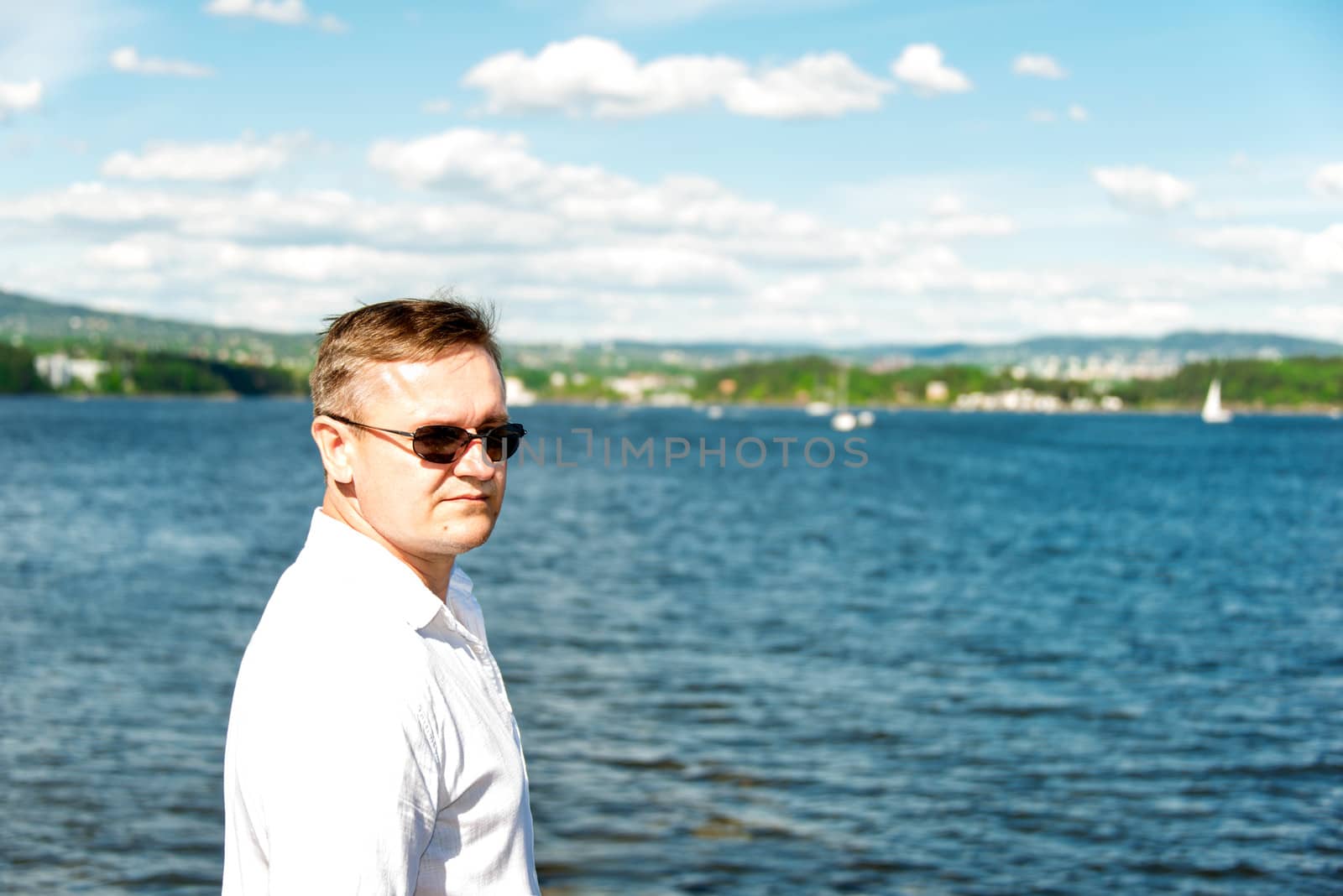 Middle aged man portrait with sea at background