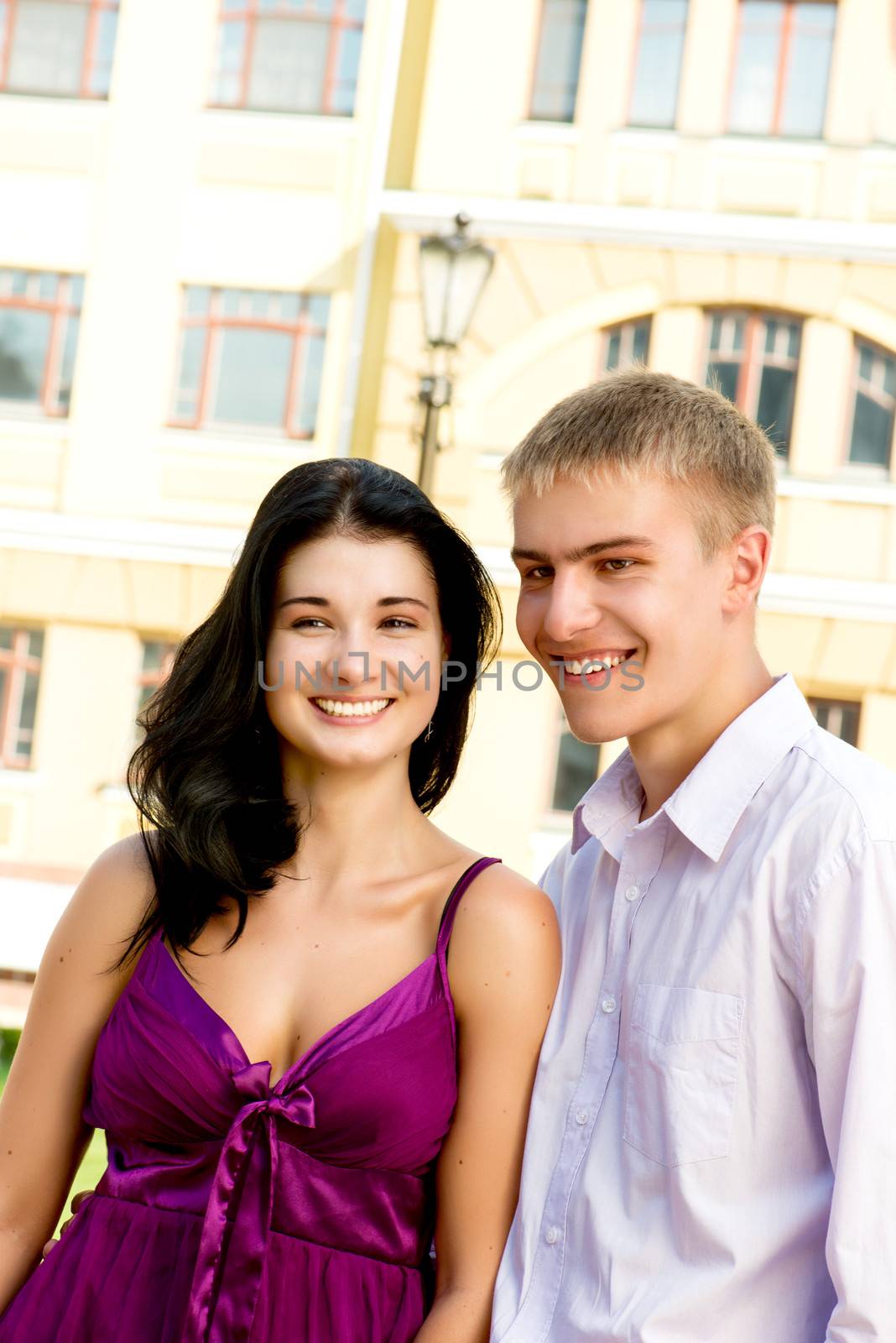Young smiling couple on street by Nanisimova