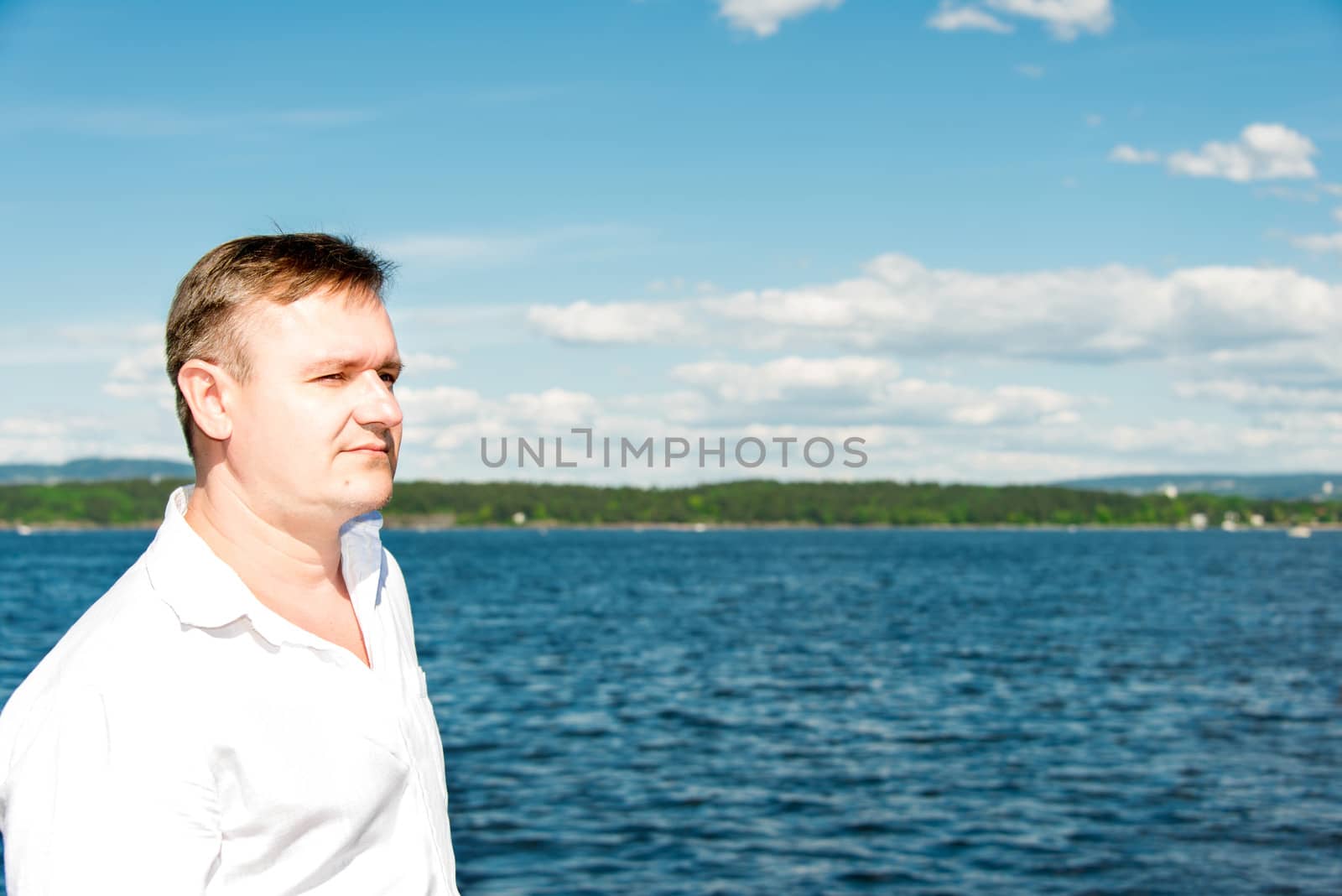 man portrait with sea on background by Nanisimova