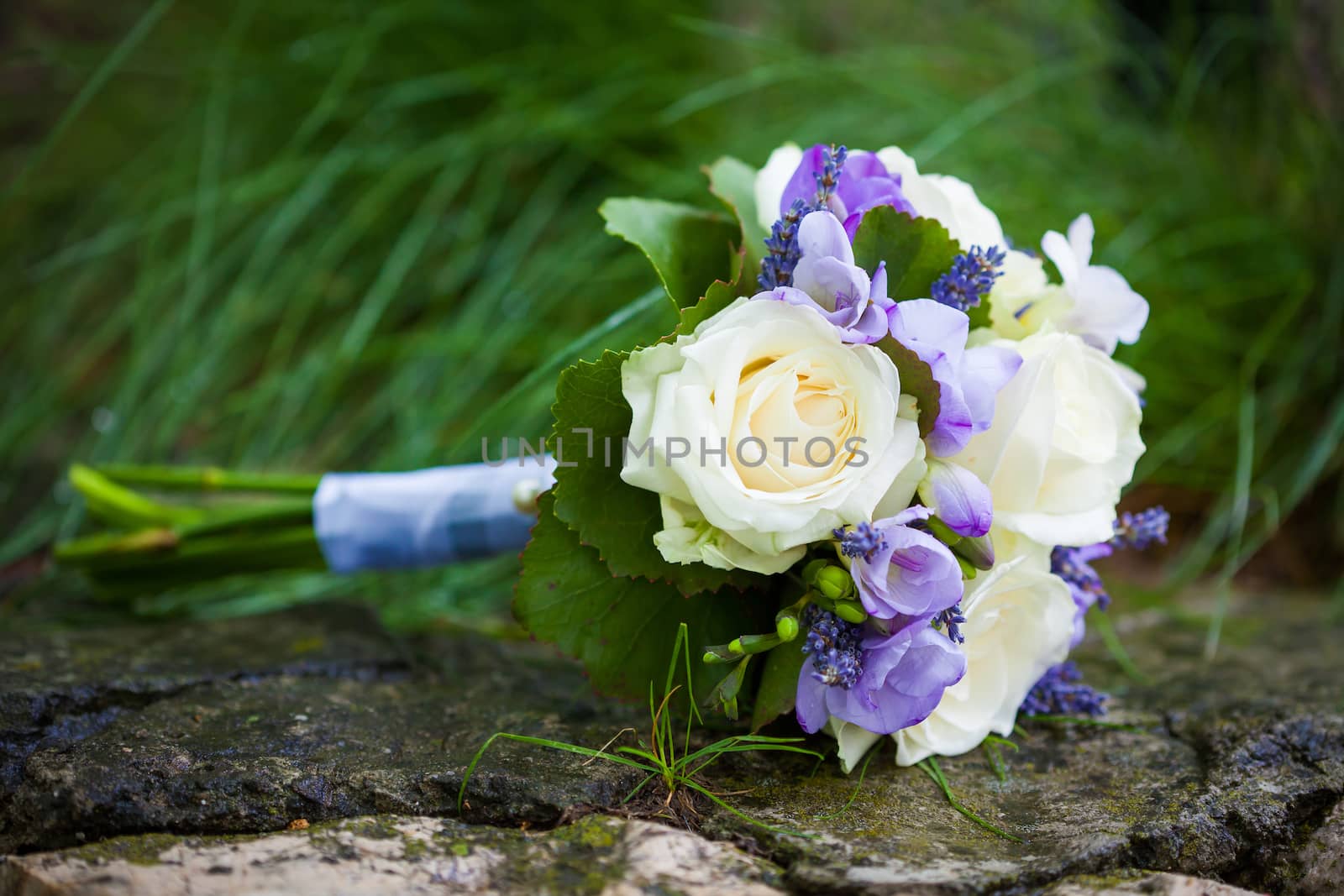 Wedding bouquet with yellow roses and lavender flowers