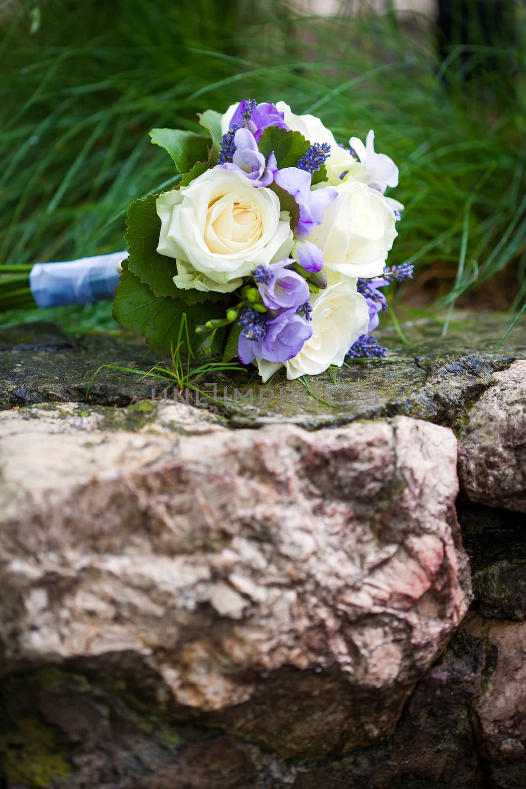 Wedding bouquet with yellow roses and lavender flowers