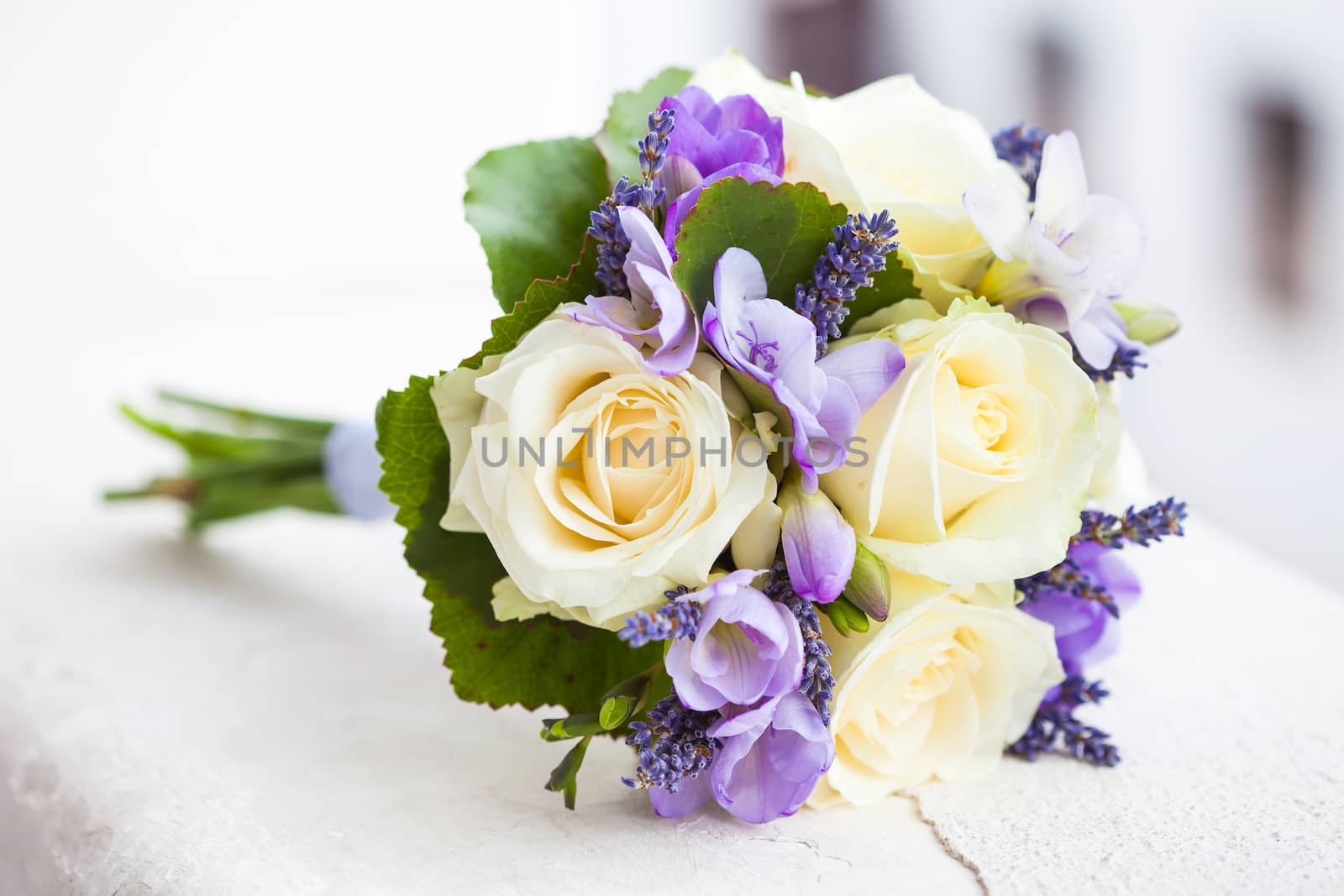 Wedding bouquet with yellow roses and lavender flowers