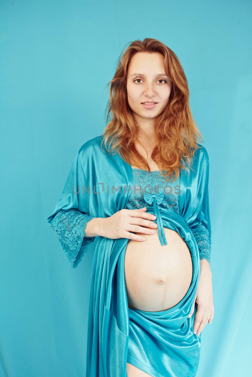 Pregnant woman on a turquoise background