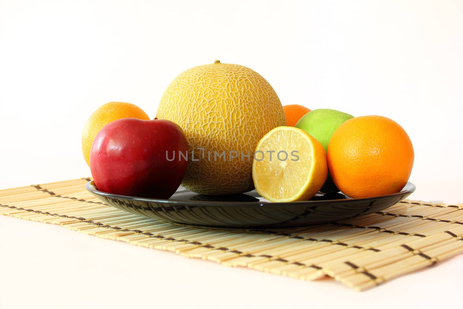 still life with fruit on a plate isolated on white background