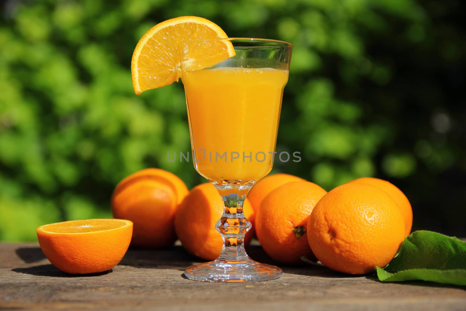 Still life with oranges and juice in a glass