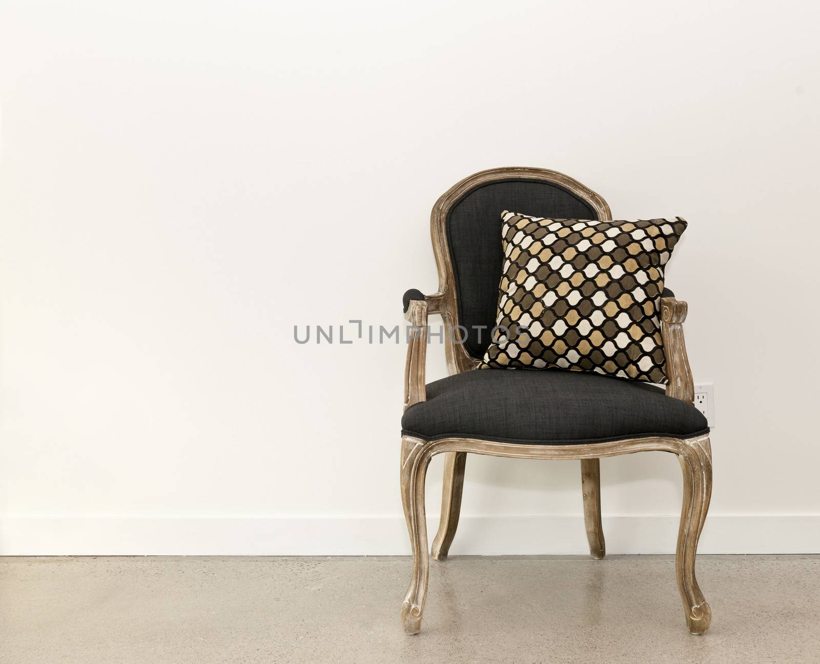 Antique armchair furniture with cushion against white wall