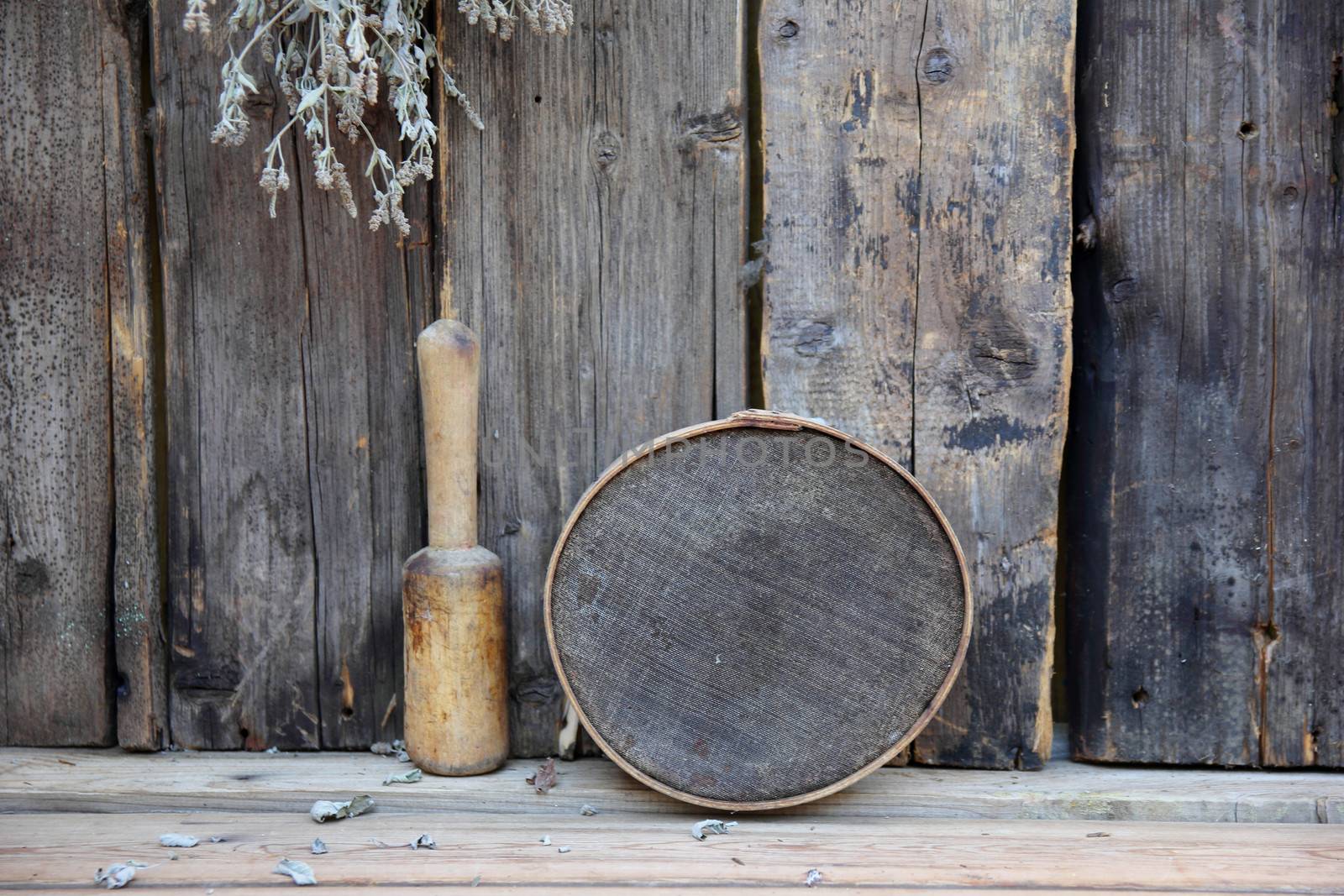 still life with antique kitchen utensils against the boards