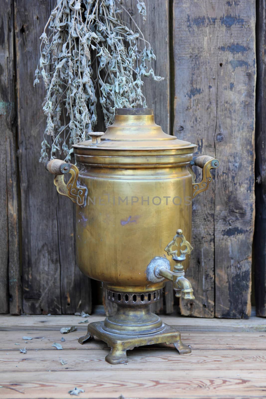 Russian samovar on a background of dry mint and old boards