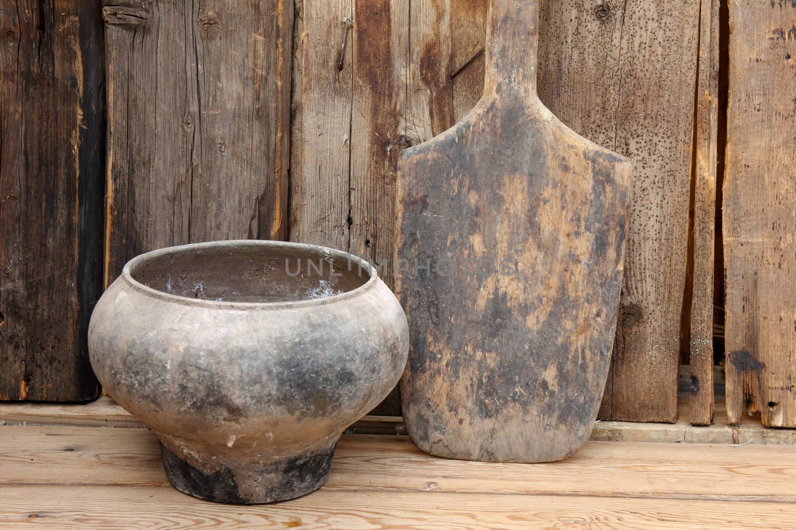 pot and shovel for bread on the wooden background