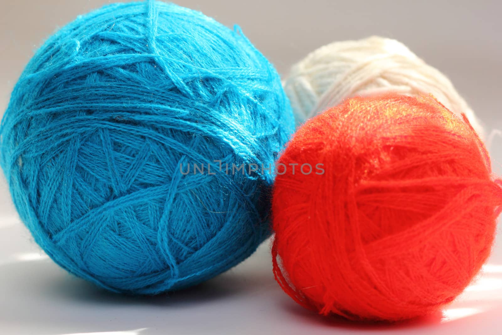red and blue balls of yarn for needlework