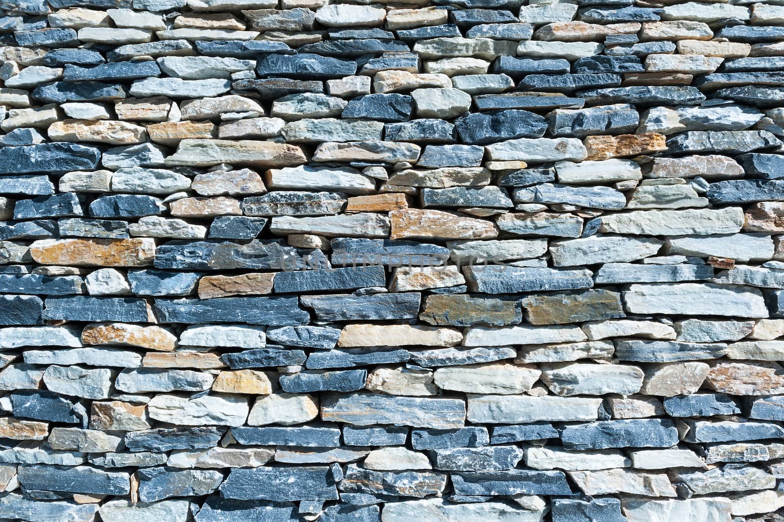 Wall of cut stone background horizontal close-up