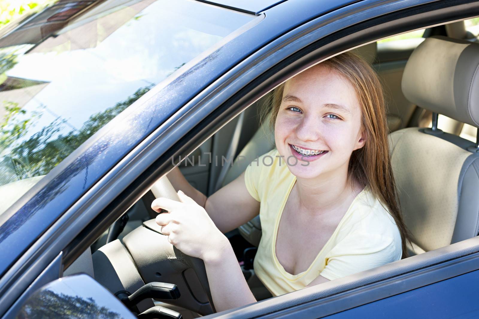 Teenage female driving student learning to drive a car