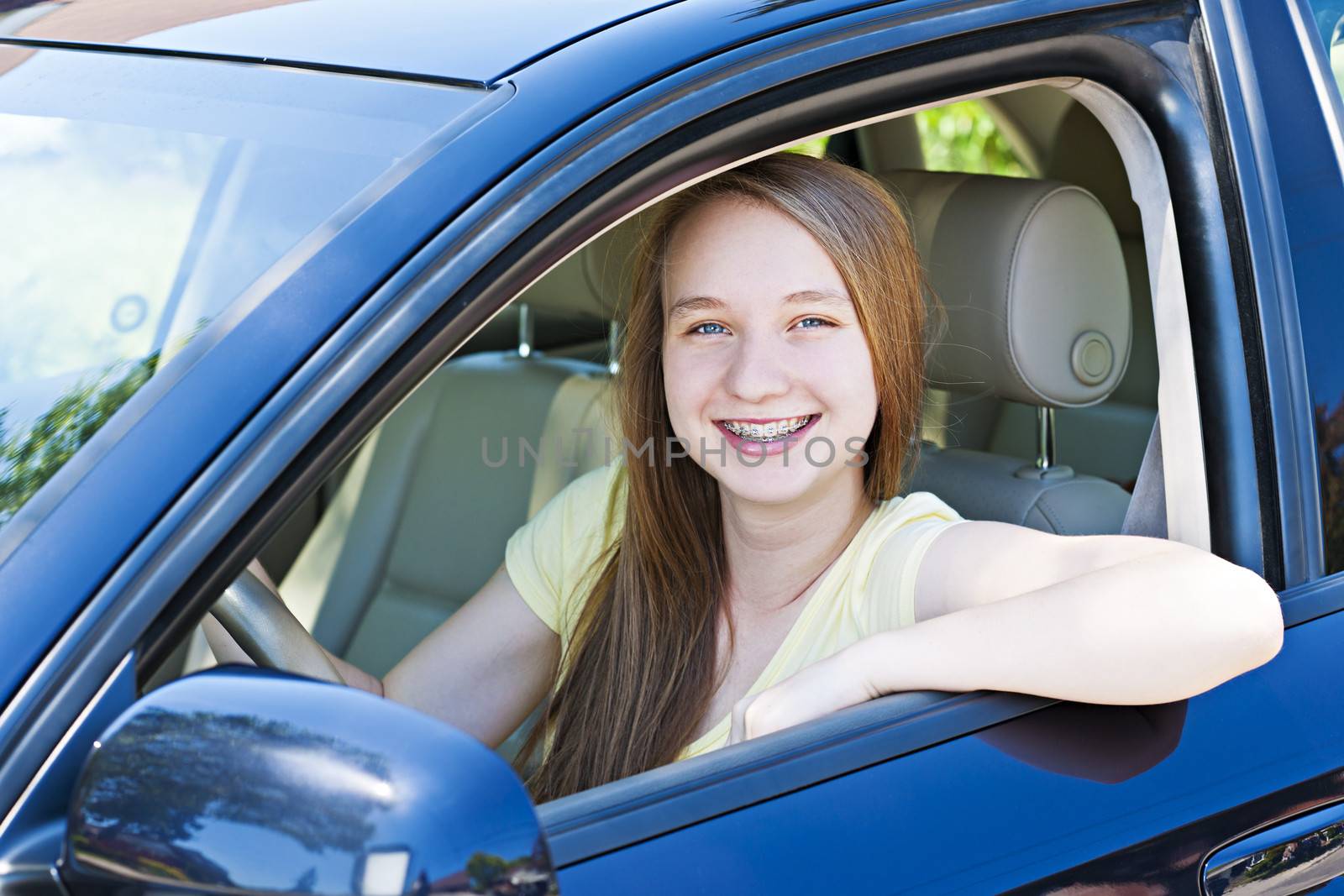 Teenage female driving student learning to drive a car
