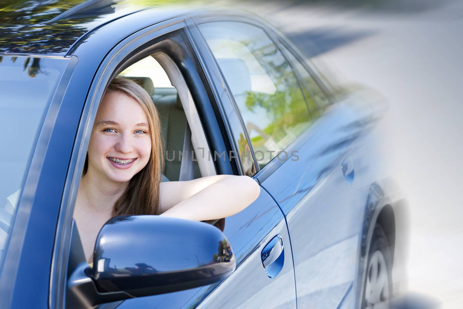 Teenage female driving student learning to drive a car