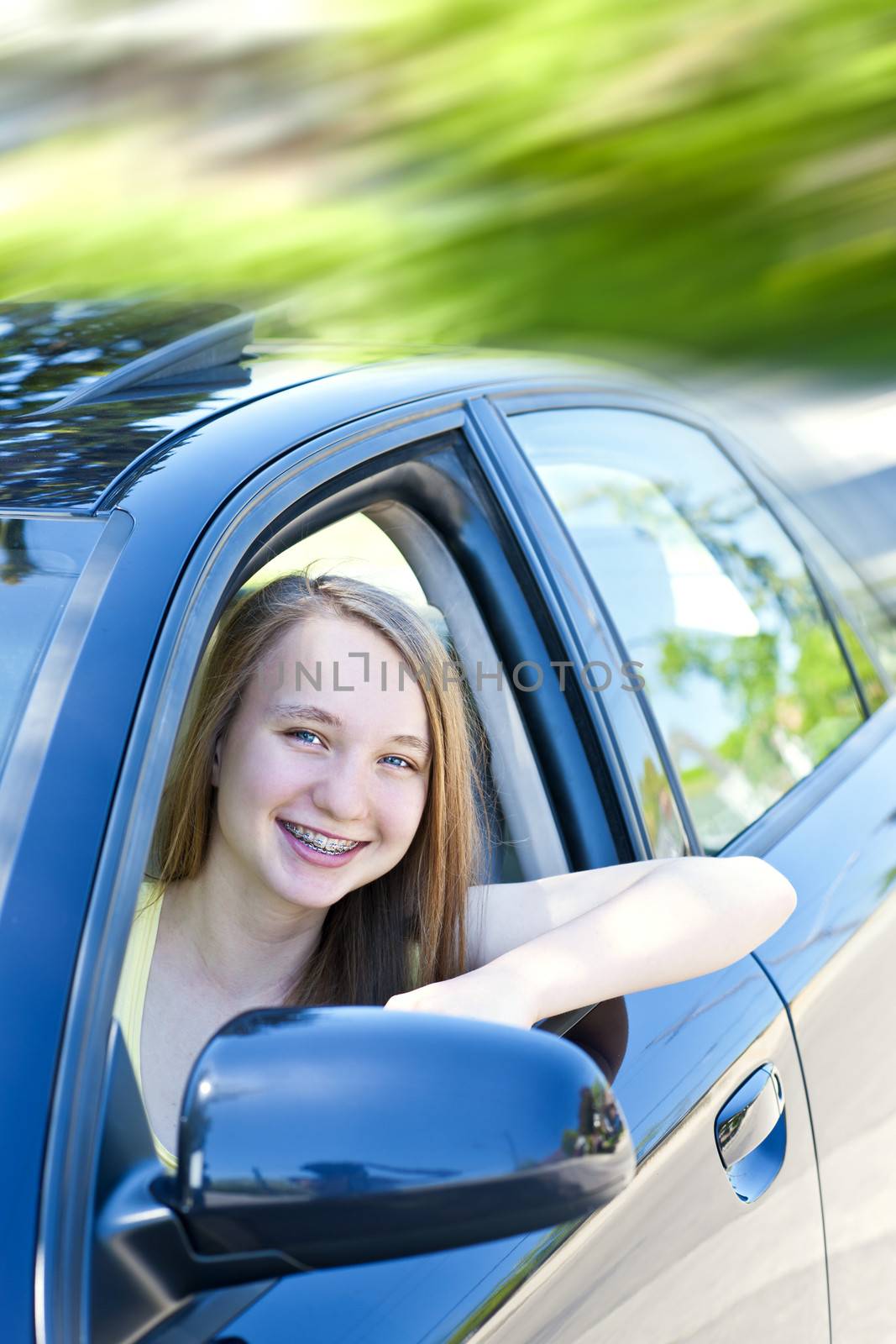 Teenage female driving student learning to drive a car