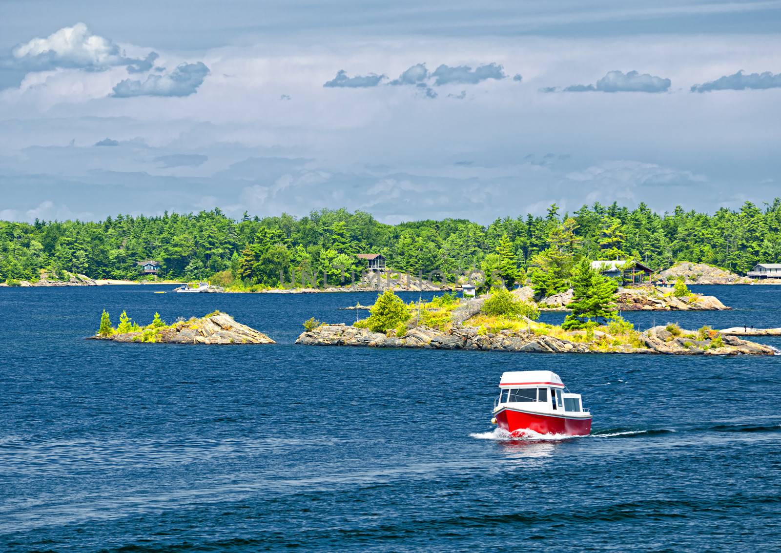 Small boat on lake near island in Georgian Bay, Ontario Canada