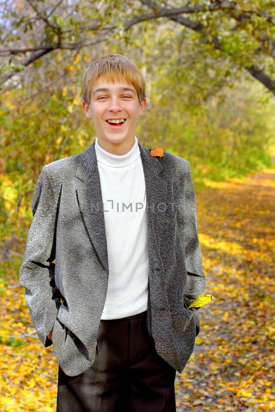 smiling teenager stand in autumn park