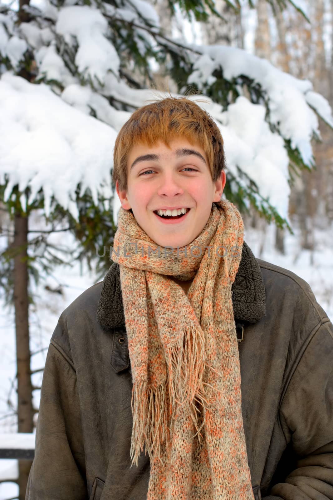 happy smiling teenager in winter forest