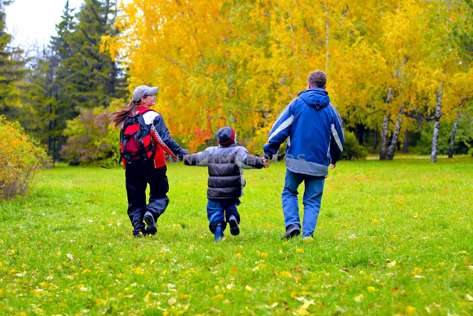 happy teenagers walking in the autumn park