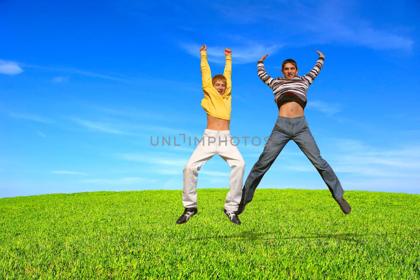 Happy smiling youth two teenage boys jumping