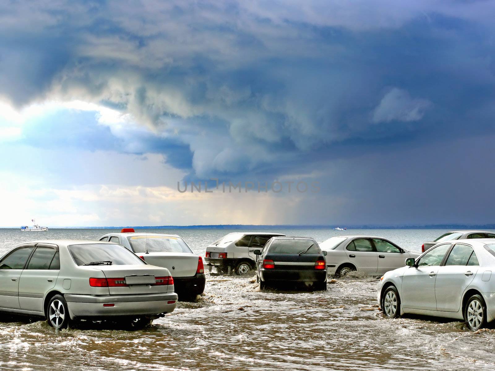 Flooding in the city with cars and driving through the water