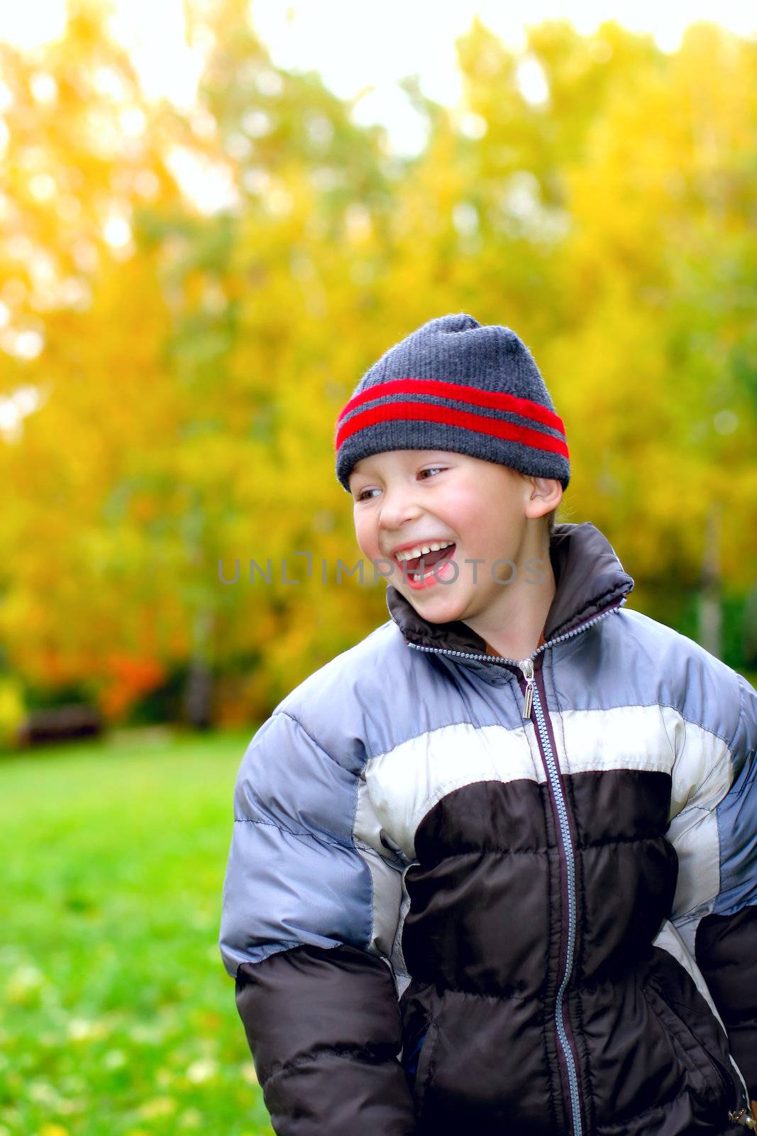 laughing kid stand in autumn park