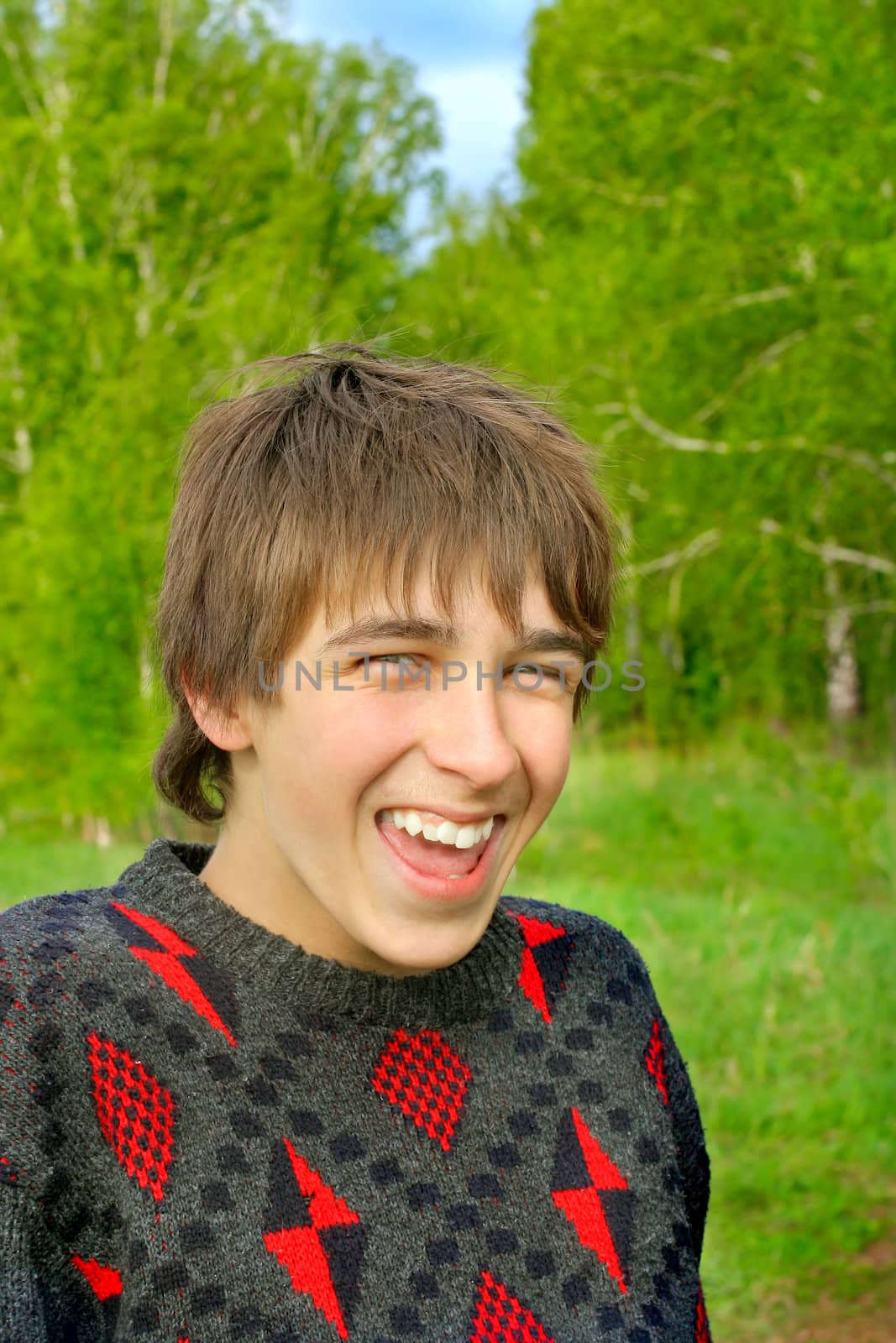 laughing teenager stand in the summer forest