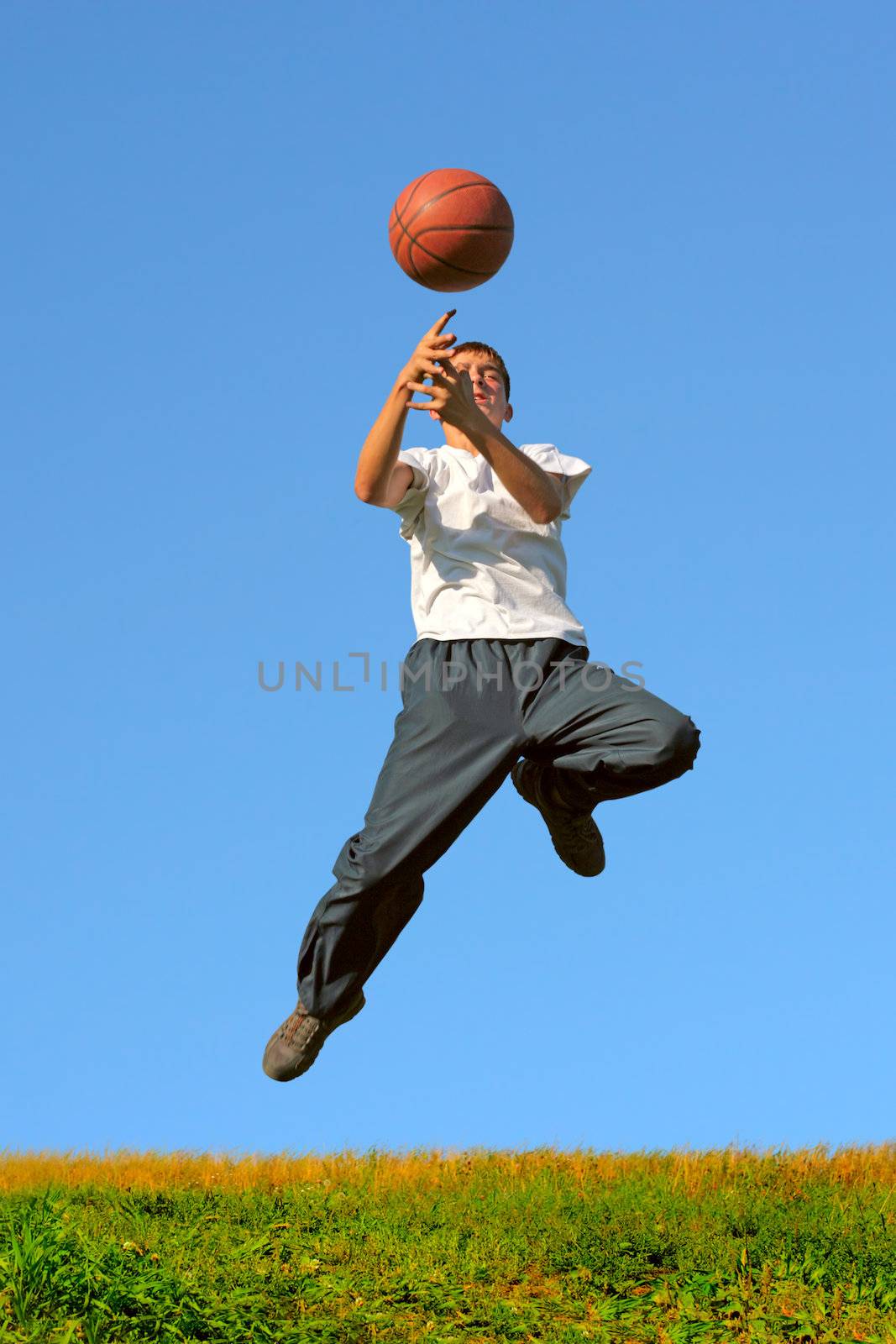 a boy dribbling a basketball in a game