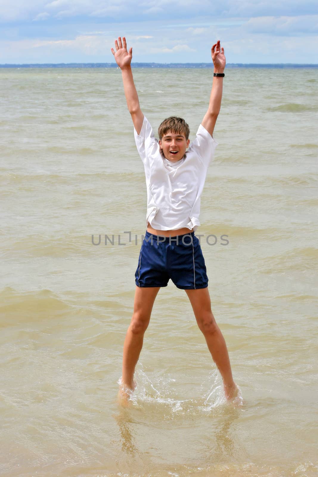 happy teenager jumping in the water