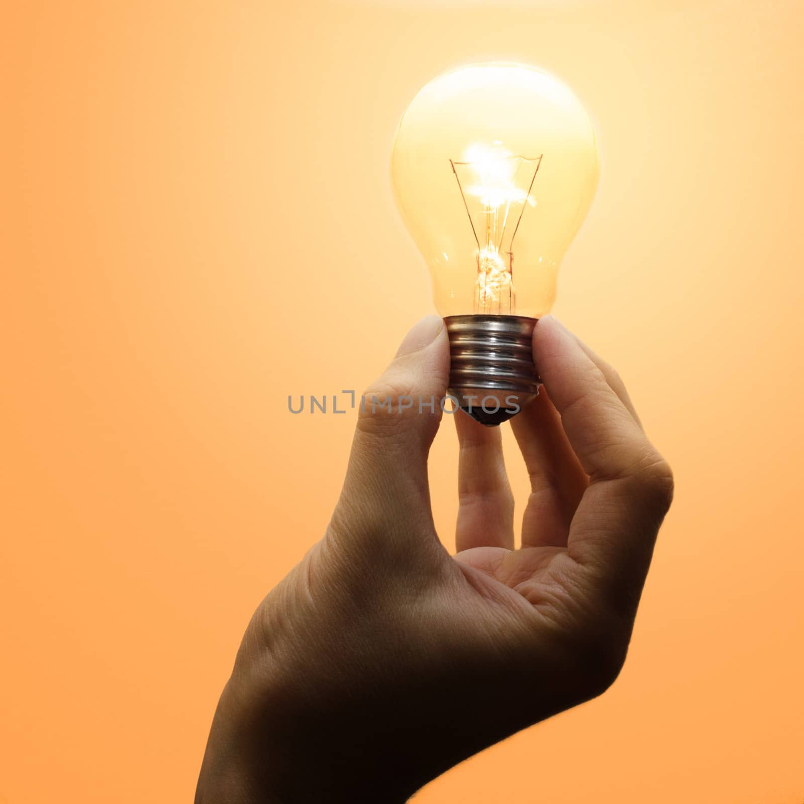 Luminescent light bulb in human hand by nprause