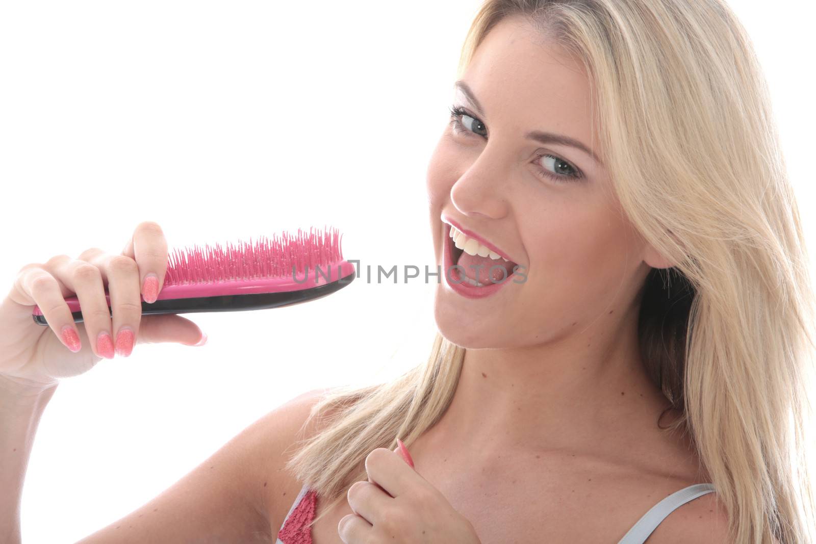 Model Released. Attractive Young Woman Singing into a Hairbrush