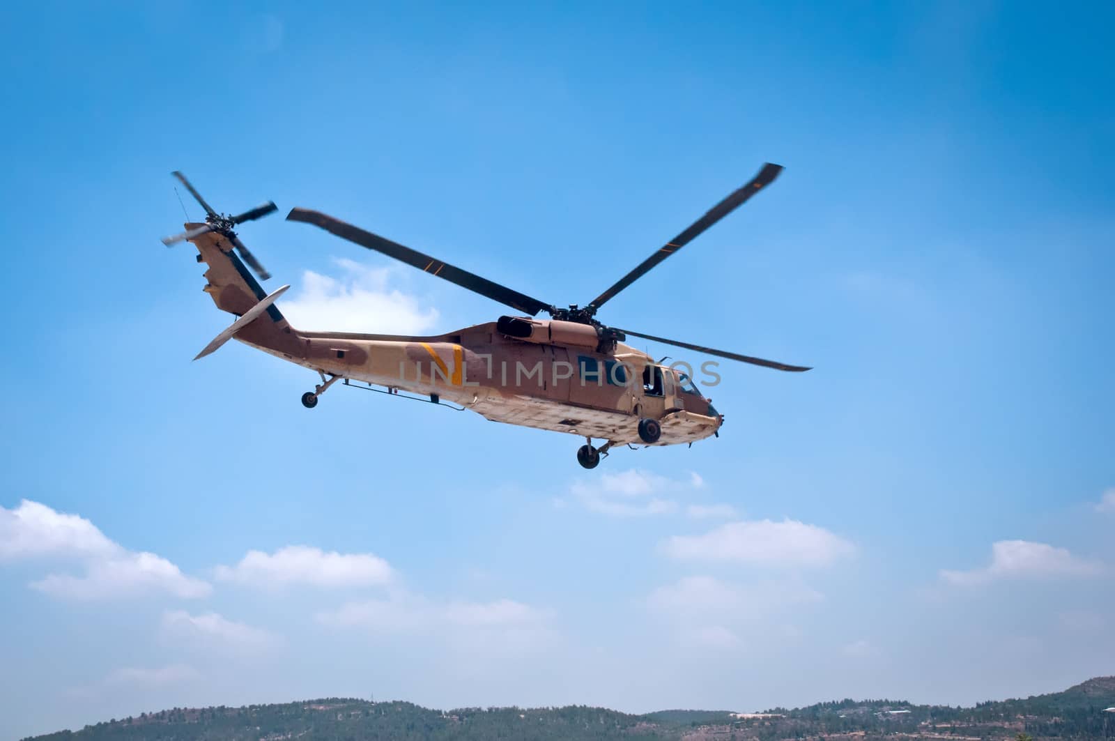 Helicopter flying over the forest near Jerusalem .