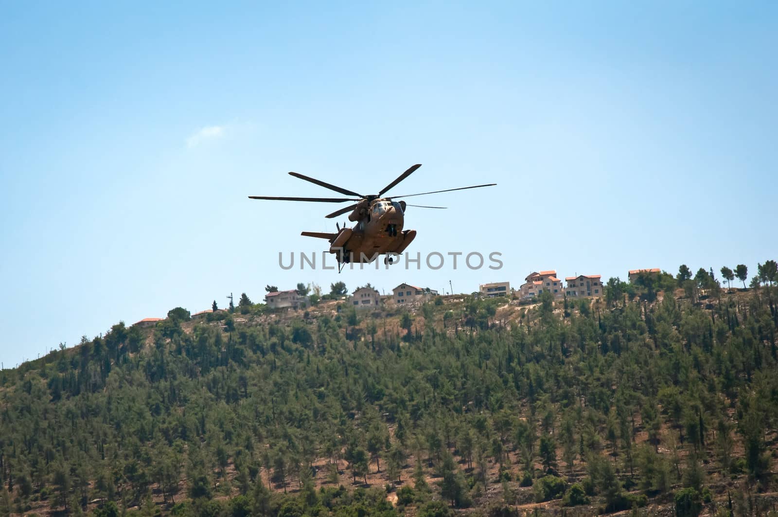 Helicopter flying over the forest near Jerusalem .
