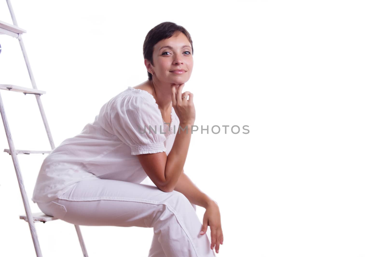 Happy woman sitting on step ladder isolated on white