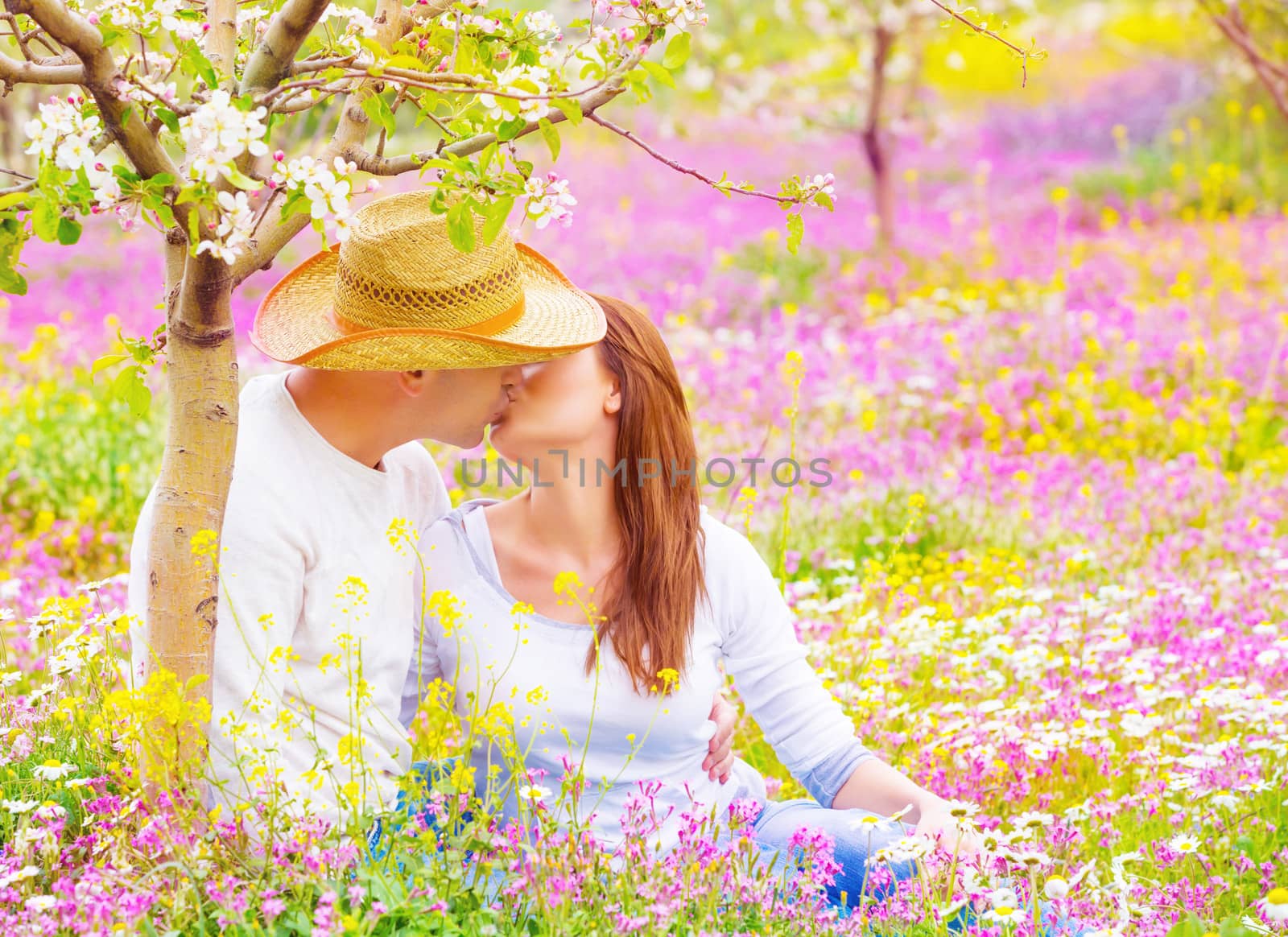 Young family kissing in garden by Anna_Omelchenko