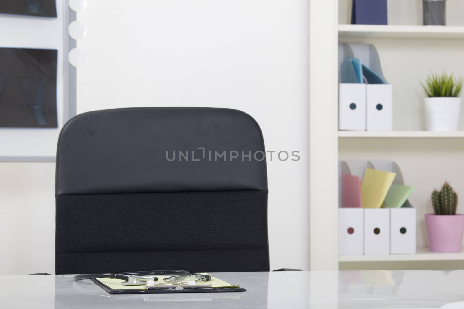 Doctor office table desk and black chair with stethoscope  and w by senkaya