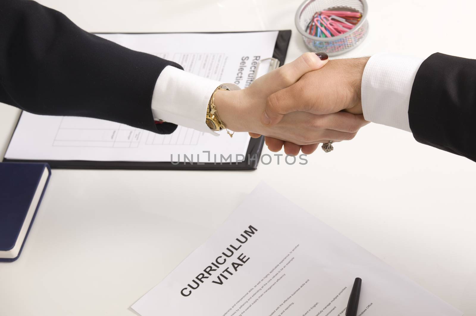 woman shaking hands with manager at job interview closeup by senkaya