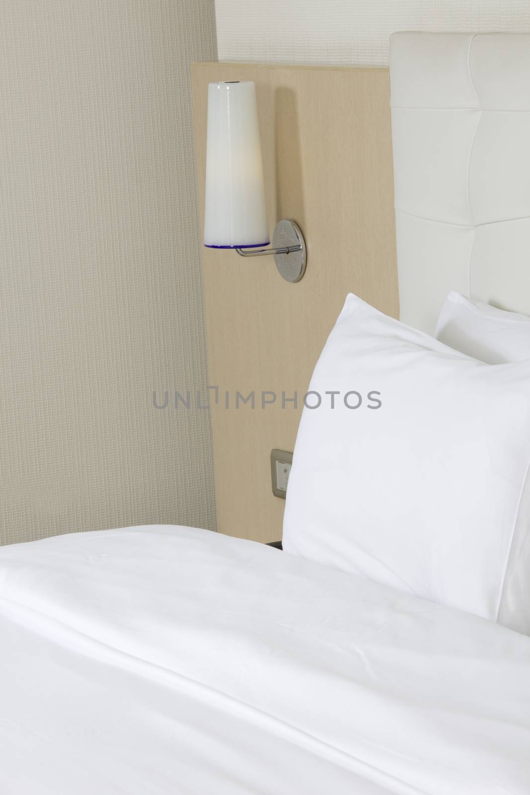 King sized bed in a luxury hotel room  by senkaya