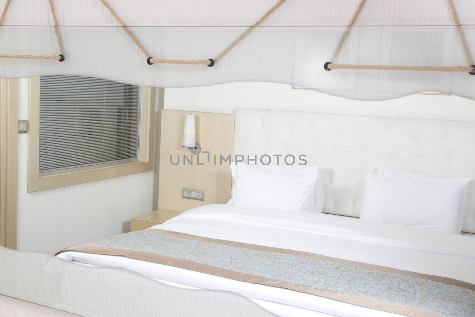 King sized bed in a luxury hotel room  by senkaya