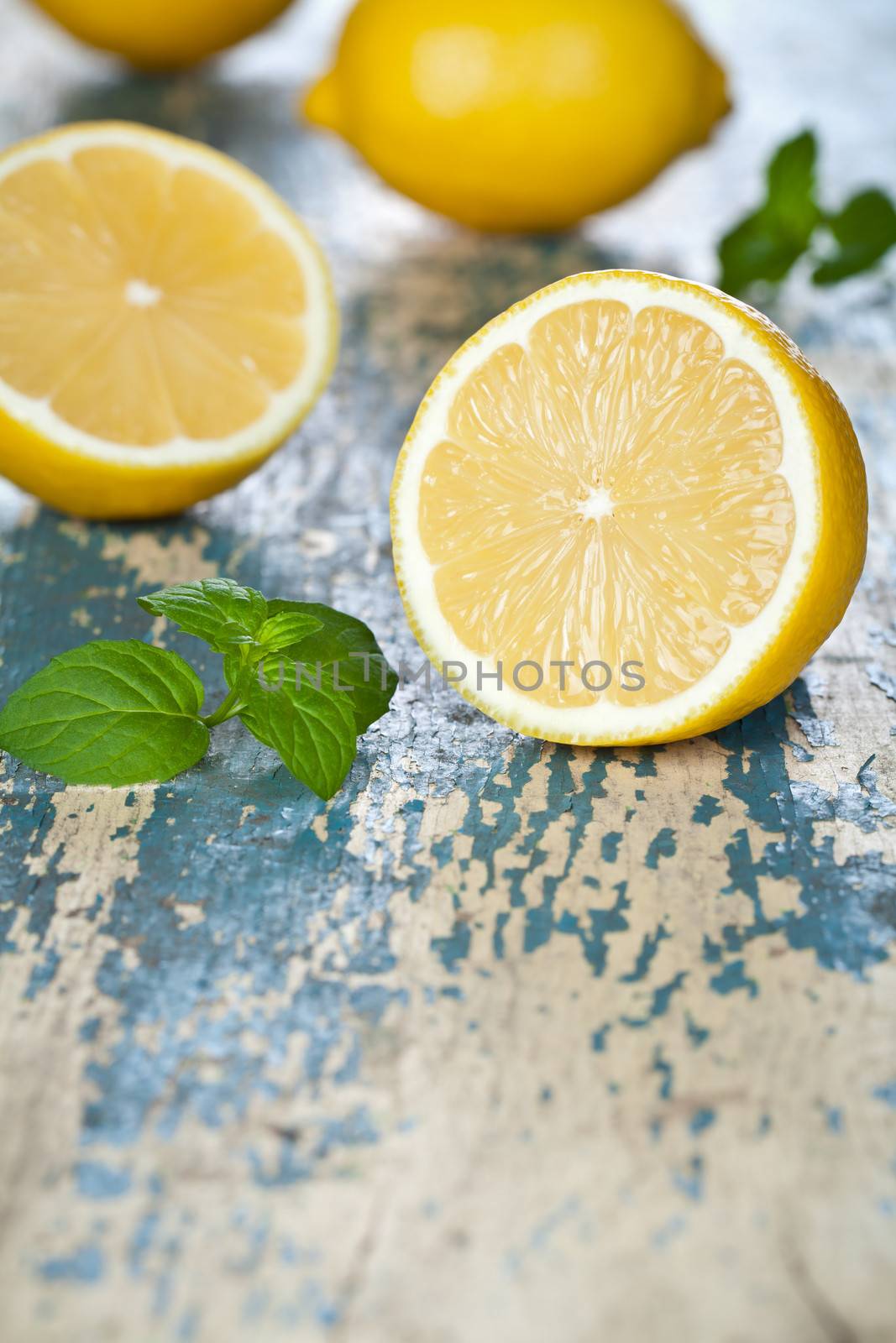 Fresh lemons with mint on wooden background. Empty room for text. Macro shot 