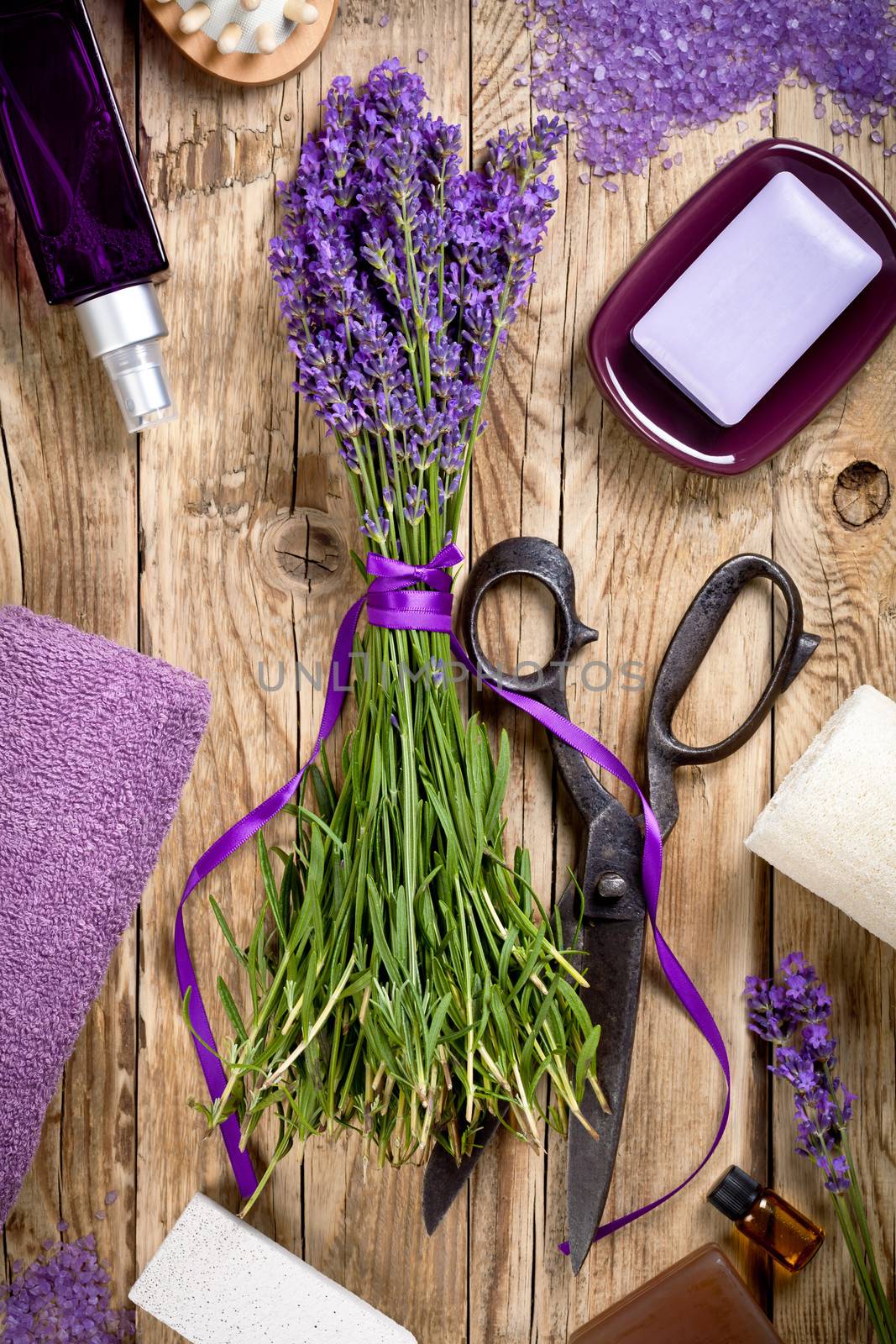 Lavender flowers with spa treatment on wooden background. Top view
