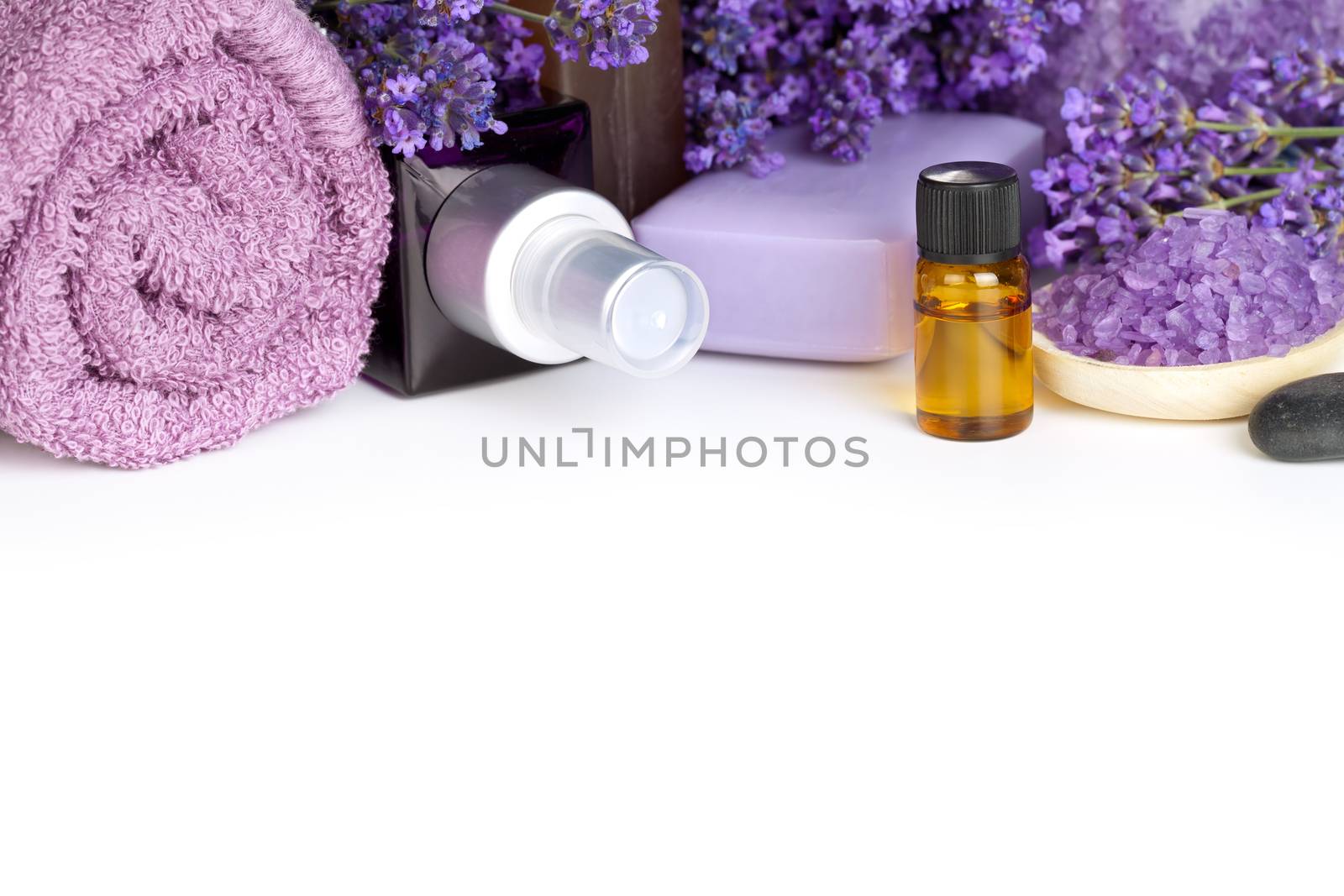 Lavender spa with flowers, oil, salt - beauty composition on white background with copy space