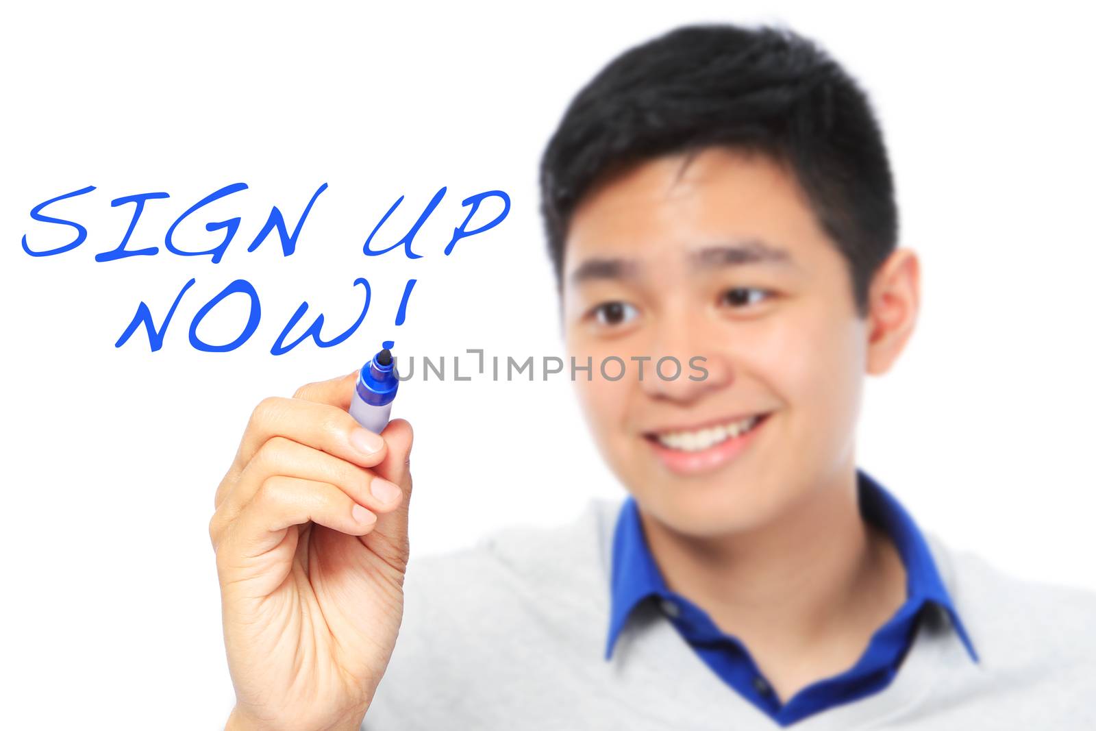 A teenager writing an invitation on a whiteboard