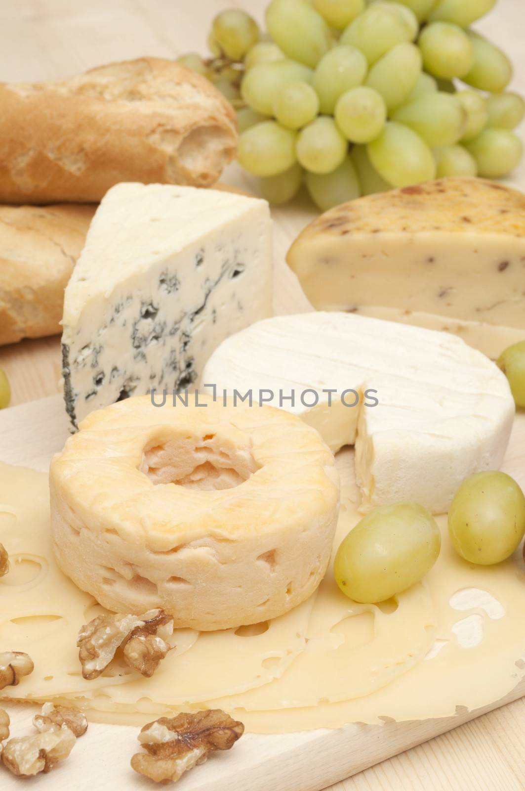 Various Types of Cheese and Grapes on Wooden Chopping Board 