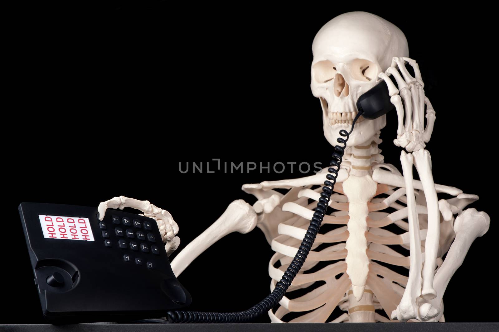 A skeletal call centre employee keeps a call on hold forever.