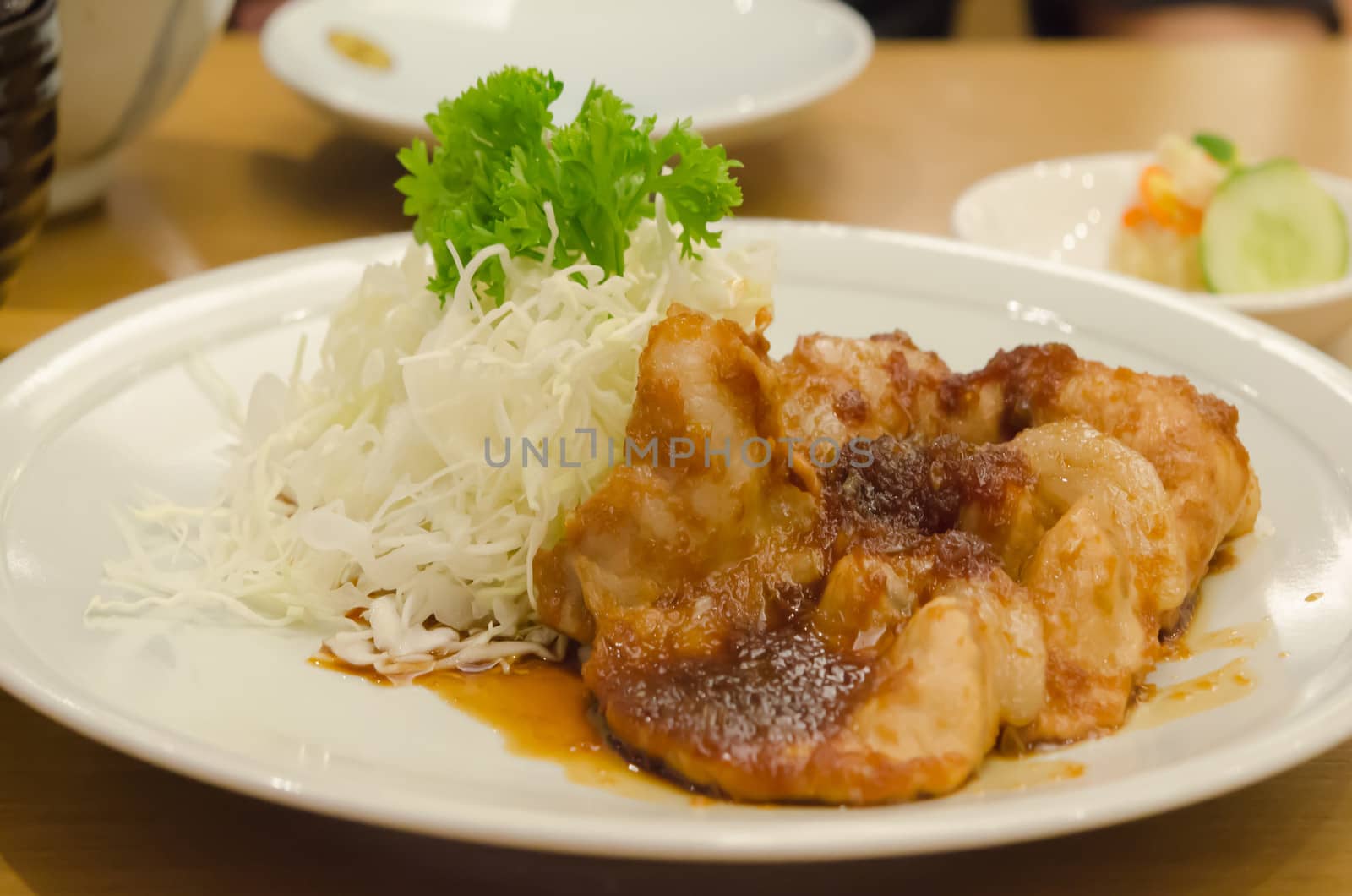 sauteed pork with ginger sauce  served with vegetable on white dish