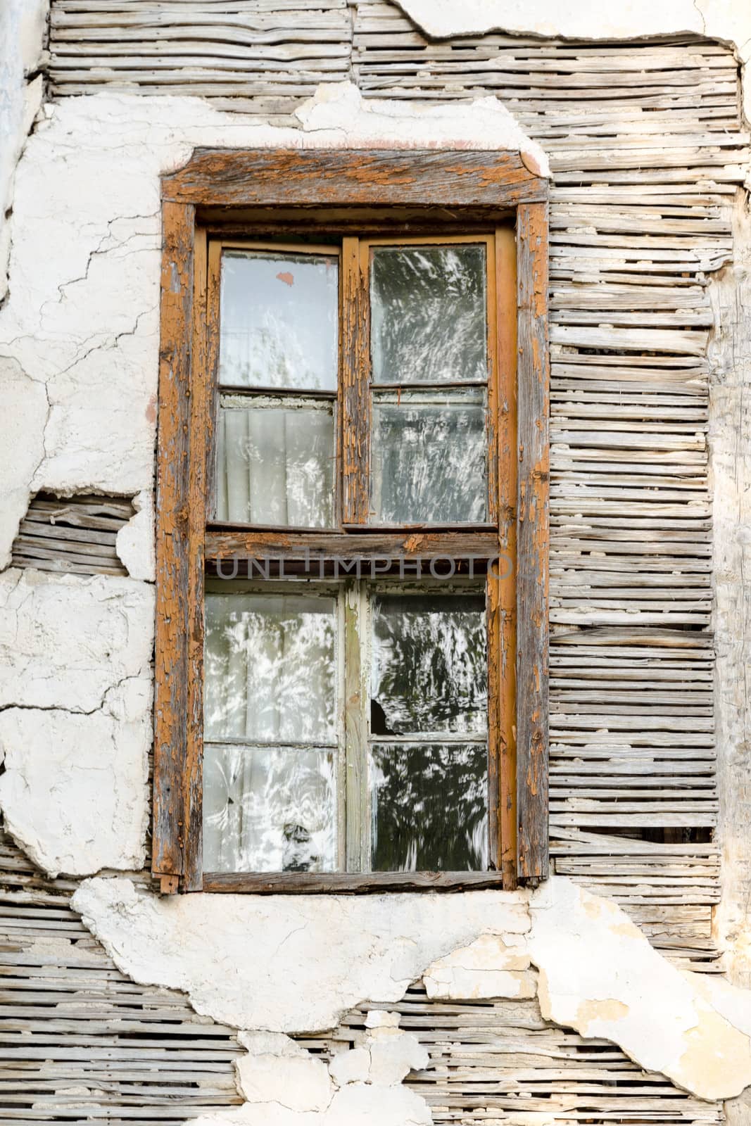 A rusty window of an abandoned house by velislava