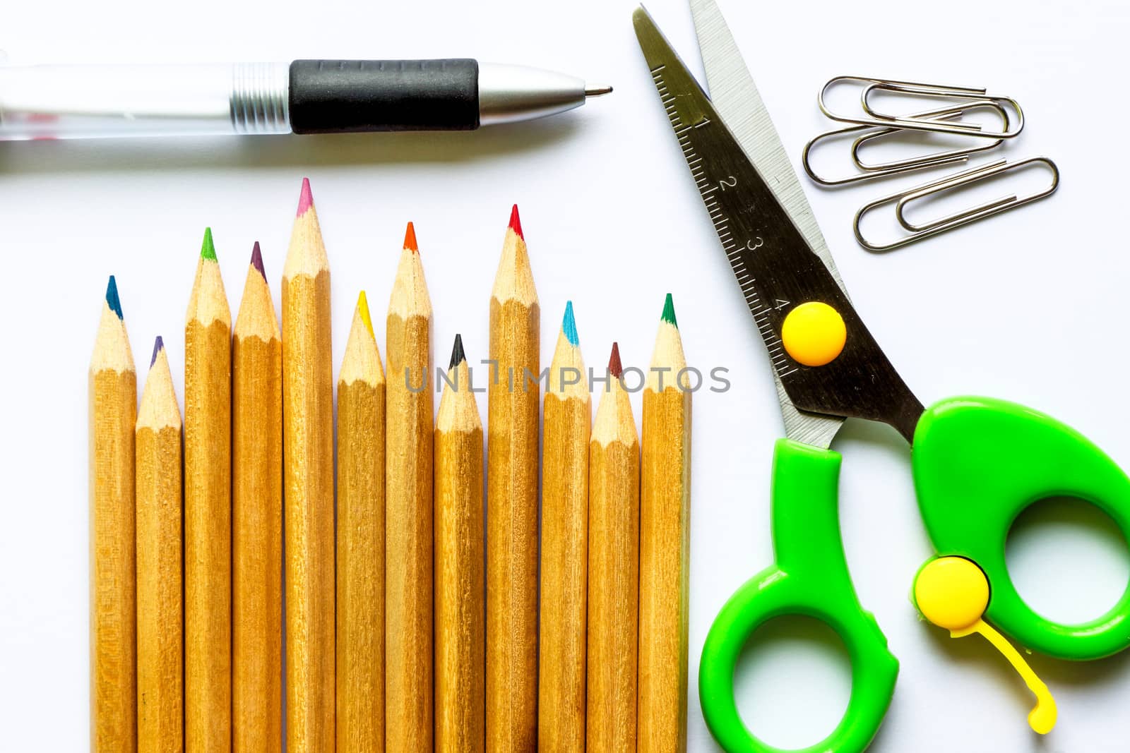 color pencils and school suppiles on white paper