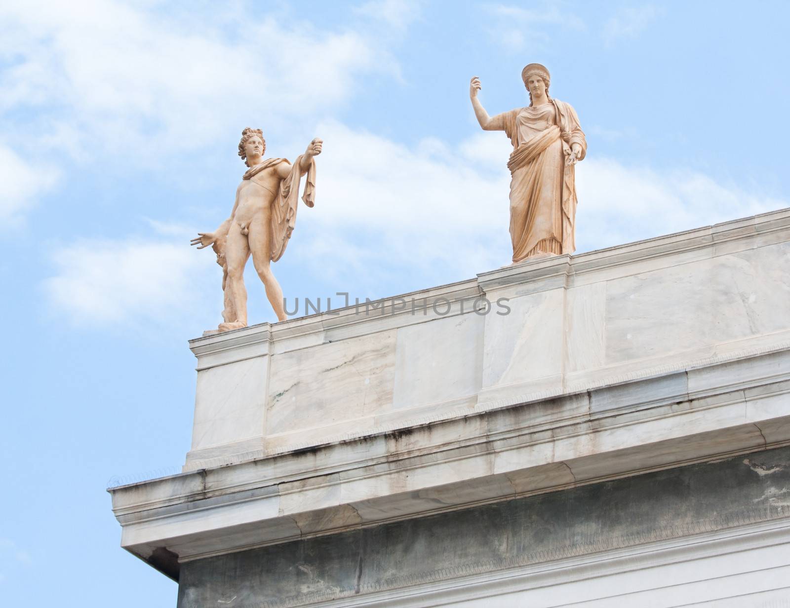 Sculptures of Apollo and Hera on the roof-top above the entrance of the National Archaeological Museum of Athens in Greece.